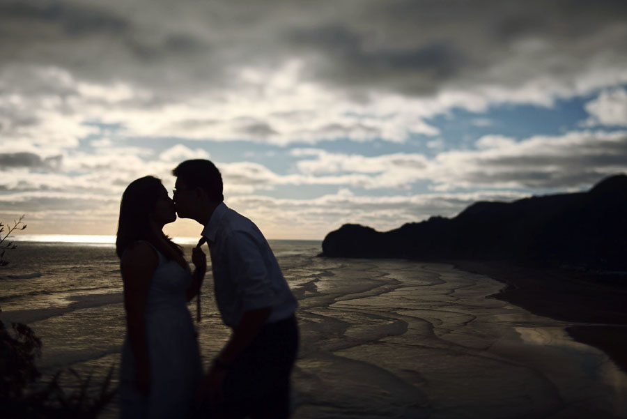 piha beach, lion rock, auckland new zealand engagement photo