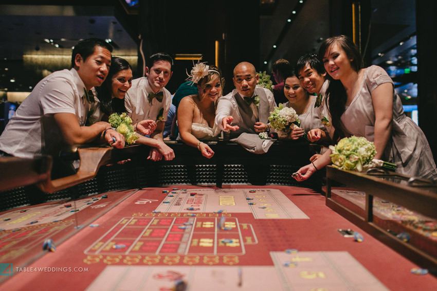 las vegas wedding, aria wedding, cosmopolitan wedding, craps table with wedding party