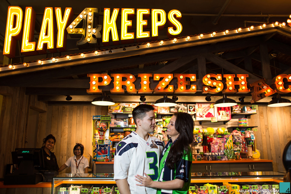 seattle seahawks fans at belmont park san diego carnival games engagement photo by wedding photographer jason huang table4 weddings