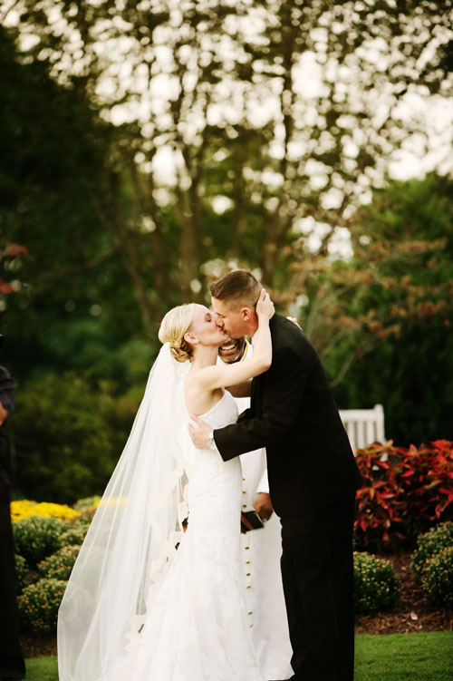 first kiss at an outdoor dallas arboretum wedding image